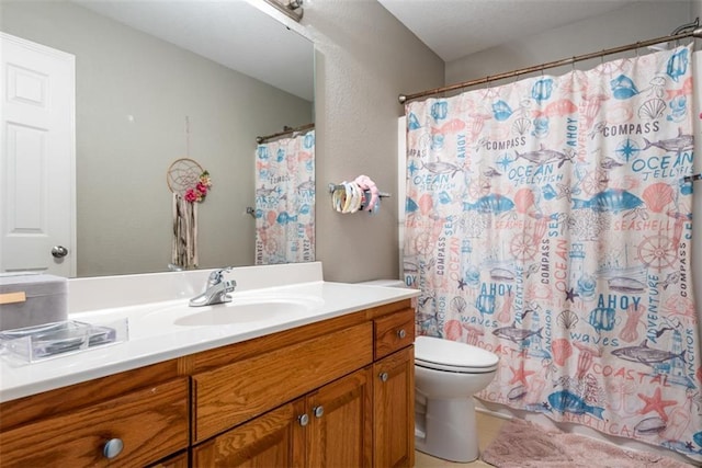 bathroom featuring toilet, vanity, and a shower with curtain