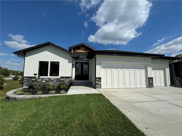 view of front of property with a front lawn and a garage