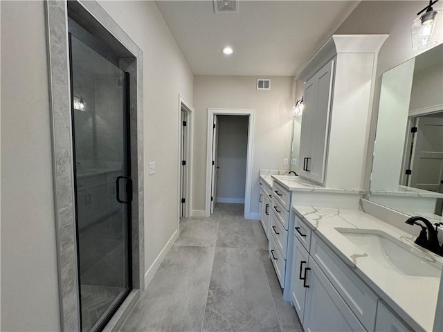 bathroom with baseboards, visible vents, a shower stall, and vanity