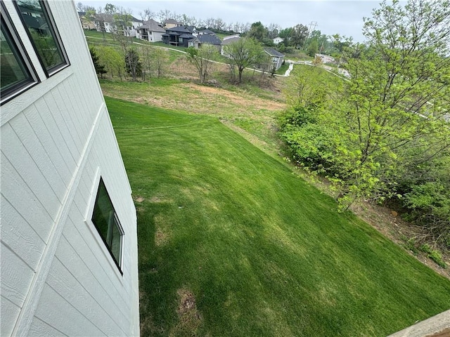view of yard featuring fence and a residential view