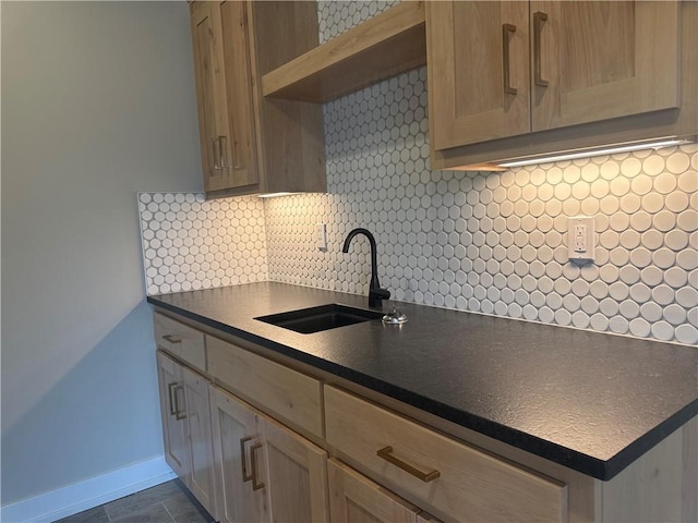 kitchen featuring sink, light brown cabinets, and decorative backsplash