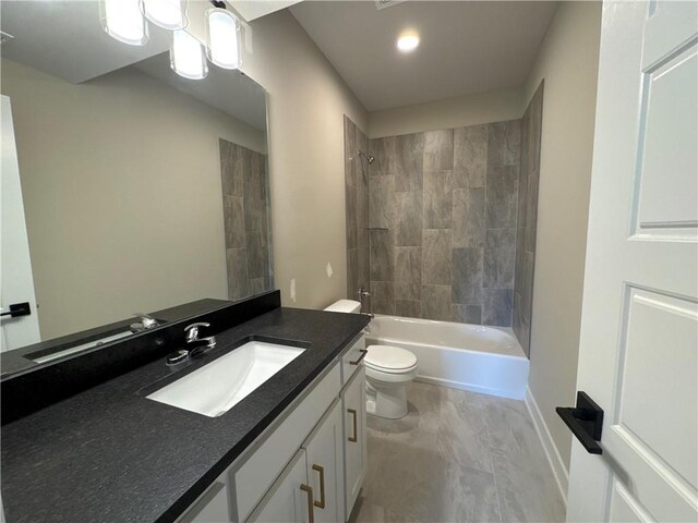 full bathroom with vanity, tiled shower / bath combo, and toilet