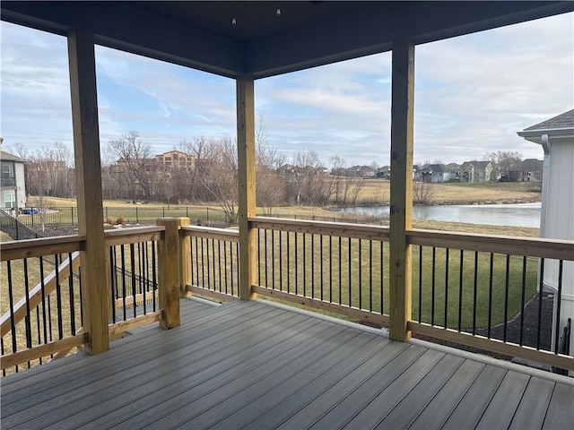 unfurnished sunroom featuring a water view