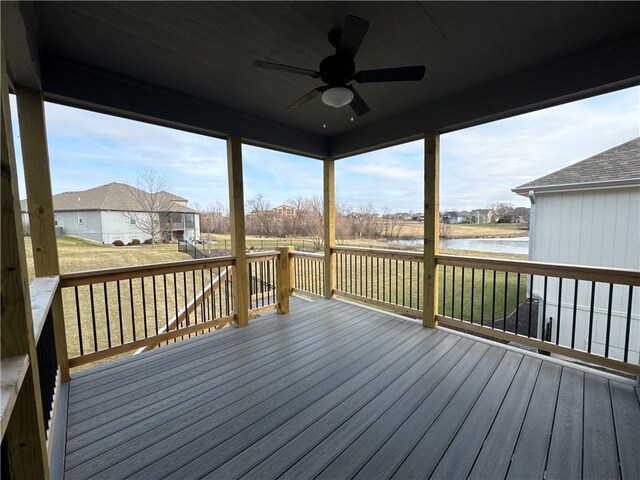 wooden terrace featuring a yard, ceiling fan, and a water view