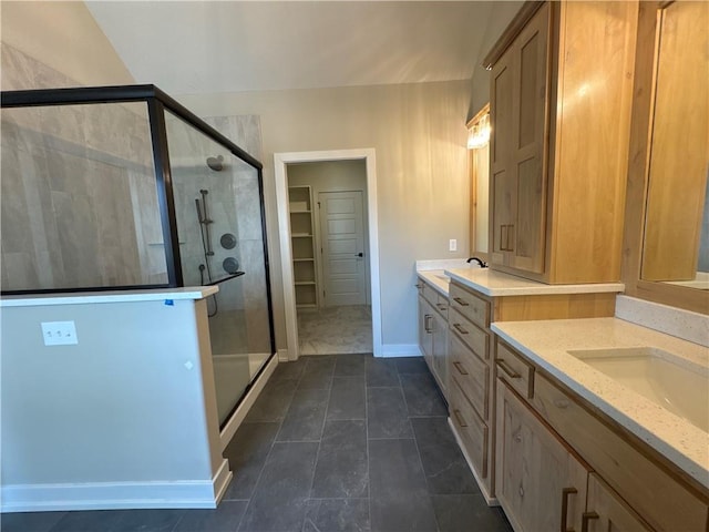 bathroom featuring an enclosed shower, vanity, and tile patterned flooring