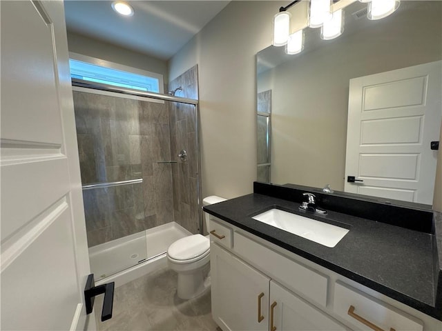 bathroom featuring vanity, toilet, and walk in shower