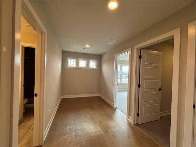 hallway with hardwood / wood-style floors