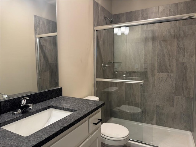 bathroom featuring walk in shower, vanity, and toilet