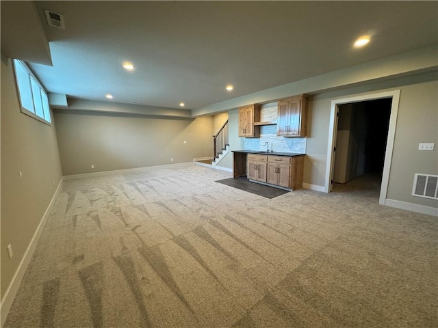 unfurnished living room featuring light carpet