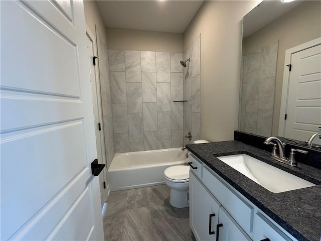 full bathroom with vanity, toilet, and tiled shower / bath