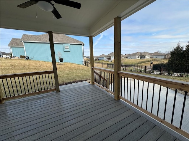 wooden deck featuring ceiling fan and a lawn