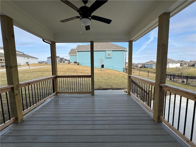 wooden deck with a yard and ceiling fan