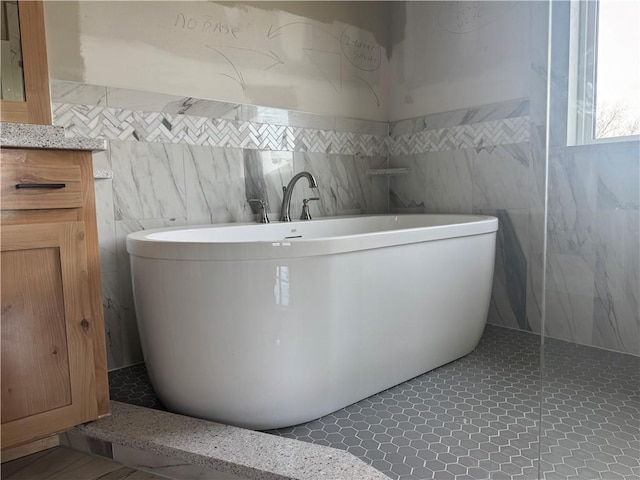 bathroom with vanity and a washtub