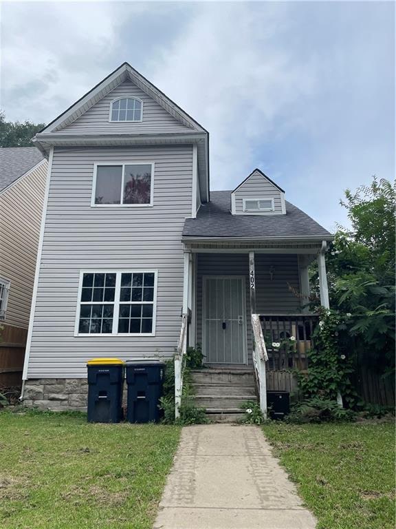 view of front of home with a front yard and a porch