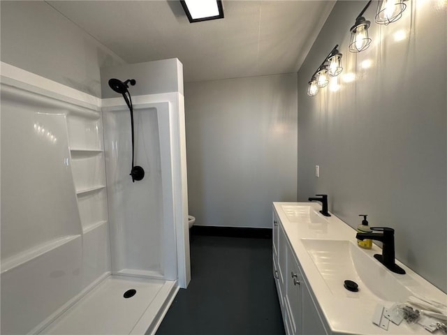 bathroom featuring a shower, vanity, and toilet