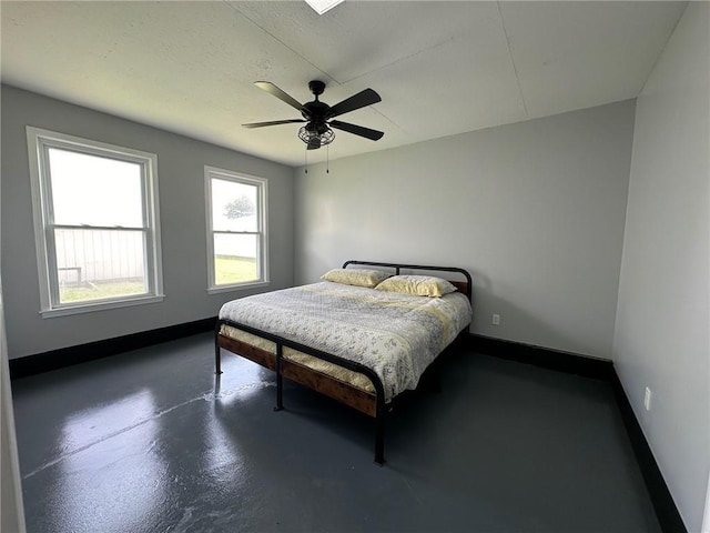 bedroom featuring ceiling fan and concrete flooring