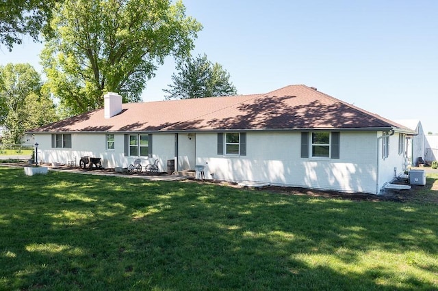 rear view of property with a yard