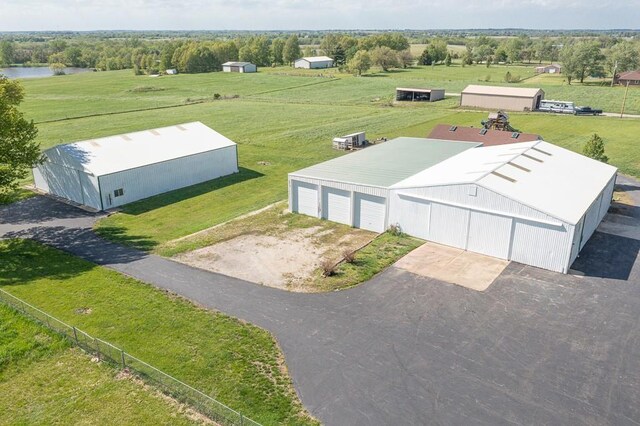 birds eye view of property featuring a water view and a rural view