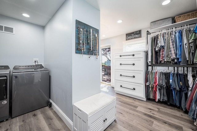 laundry area featuring light hardwood / wood-style floors and washer and dryer