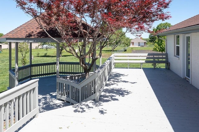 wooden deck featuring a yard