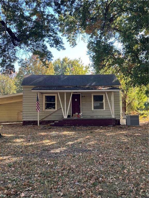 view of front of home with a porch and central AC