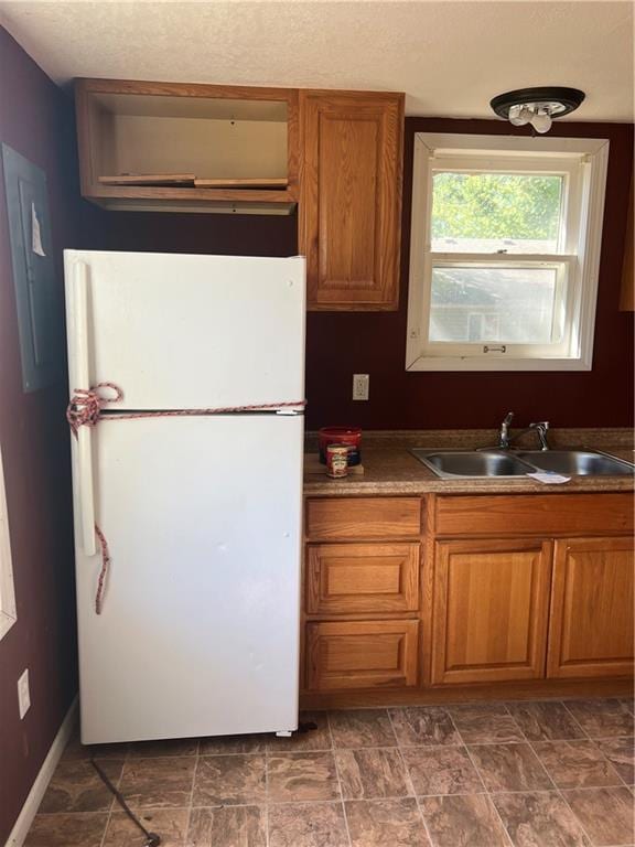 kitchen featuring white fridge and sink