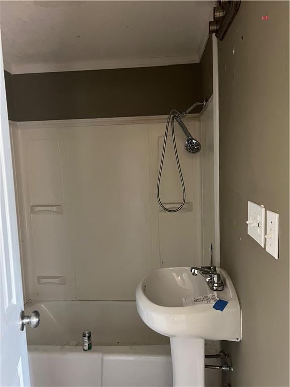 bathroom featuring crown molding and shower / tub combination