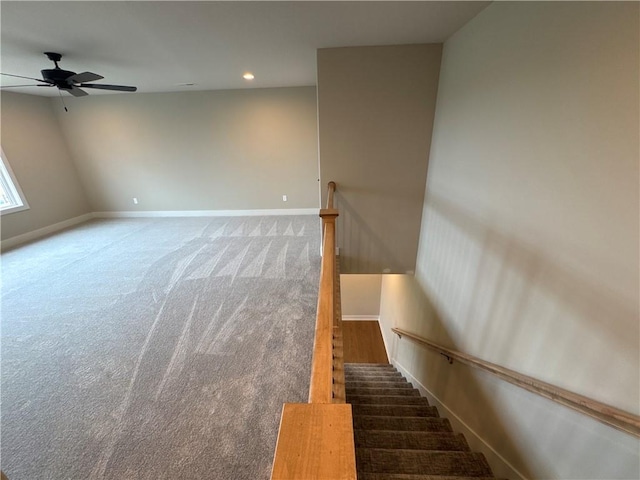 stairway with carpet and ceiling fan