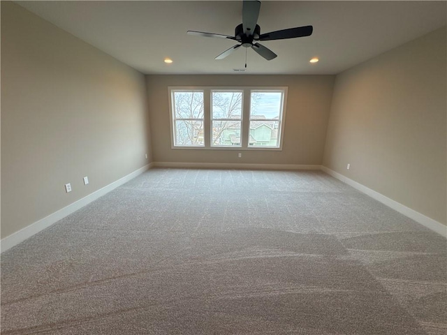 carpeted spare room with ceiling fan