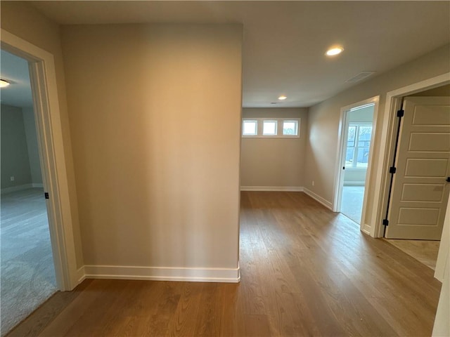 corridor with light hardwood / wood-style flooring