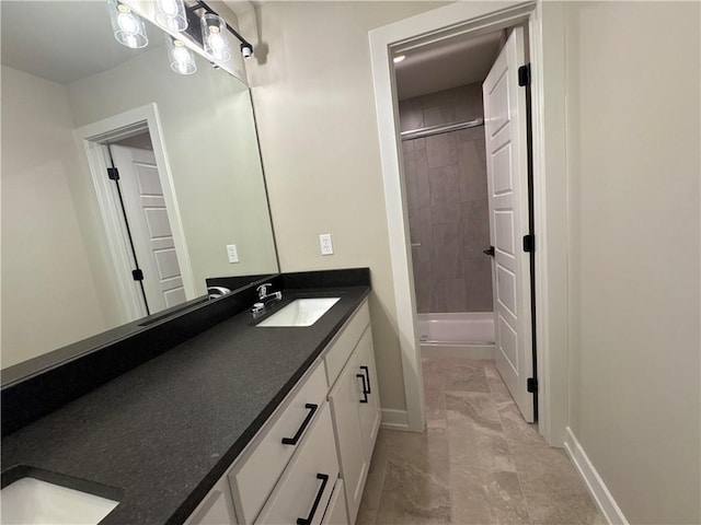 bathroom with vanity and tiled shower