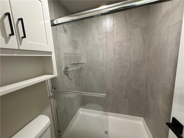 bathroom with an enclosed shower and toilet