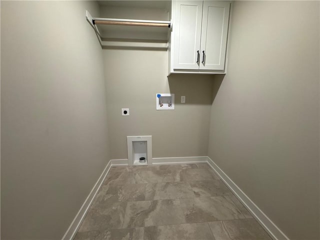 clothes washing area with electric dryer hookup, hookup for a washing machine, and cabinets