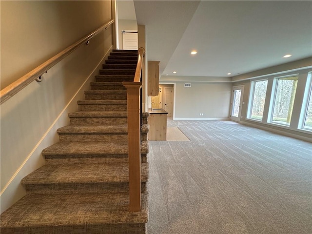 stairs featuring carpet flooring