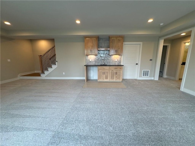 unfurnished living room featuring light carpet