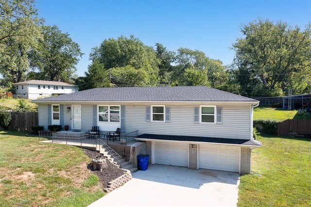 view of front of home featuring a garage and a front lawn