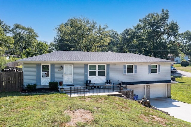 view of front of property with a front yard and a garage