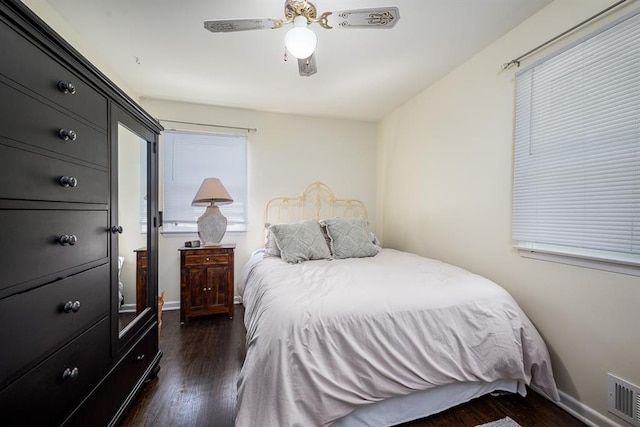 bedroom with ceiling fan and dark wood-type flooring