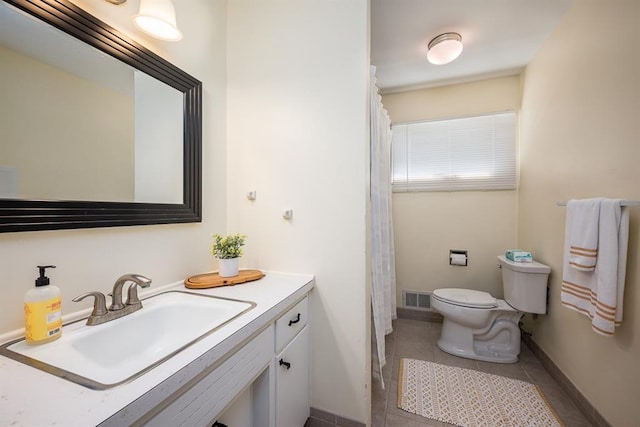 bathroom featuring vanity, tile patterned flooring, and toilet