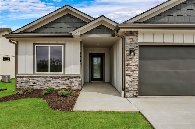 entrance to property with central AC unit and a garage