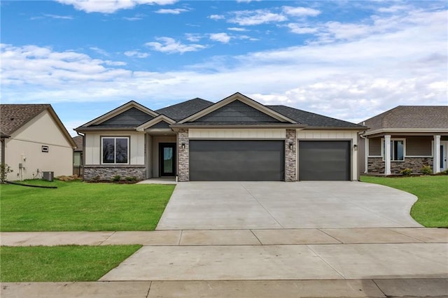 view of front of home with driveway, stone siding, an attached garage, a front lawn, and board and batten siding