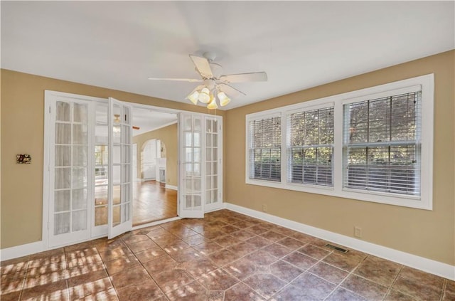 unfurnished room with tile patterned flooring, ceiling fan, and french doors