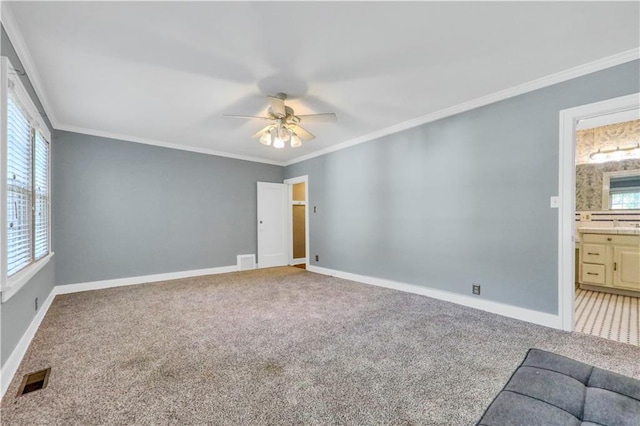 empty room featuring crown molding, ceiling fan, and carpet flooring