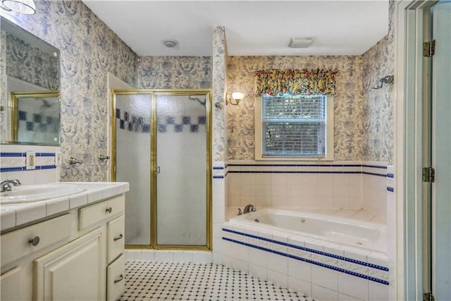 bathroom featuring vanity and shower with separate bathtub