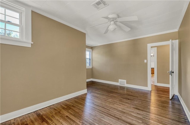 empty room with crown molding, ceiling fan, and hardwood / wood-style floors