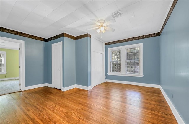 spare room featuring hardwood / wood-style flooring and ceiling fan