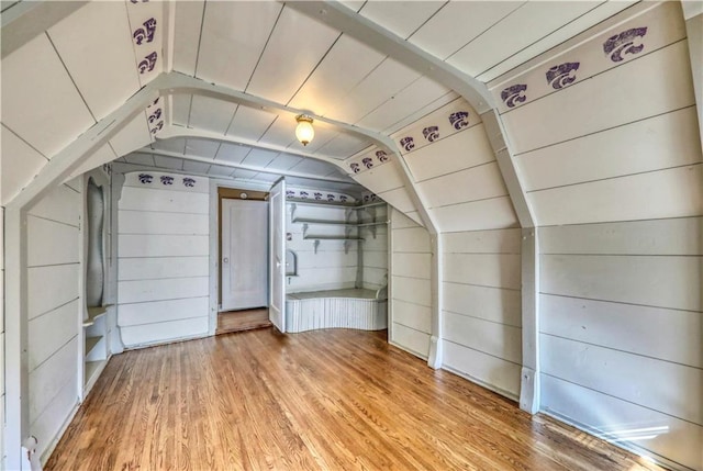 bonus room featuring hardwood / wood-style flooring, vaulted ceiling, wooden ceiling, and wood walls