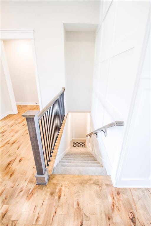 staircase with hardwood / wood-style floors