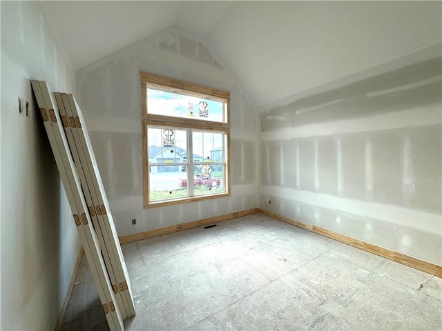 bonus room featuring baseboards and lofted ceiling