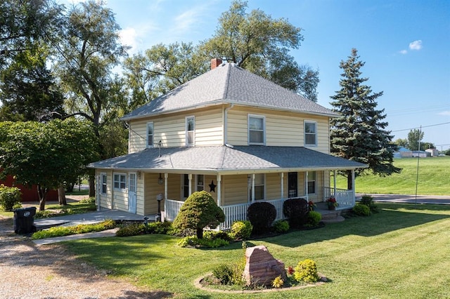 view of front of home with a porch and a front lawn